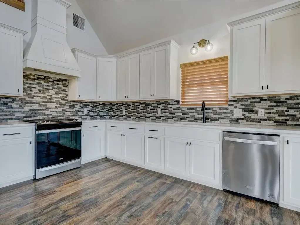 Newly renovated kitchen with new tile backsplash and flooring.