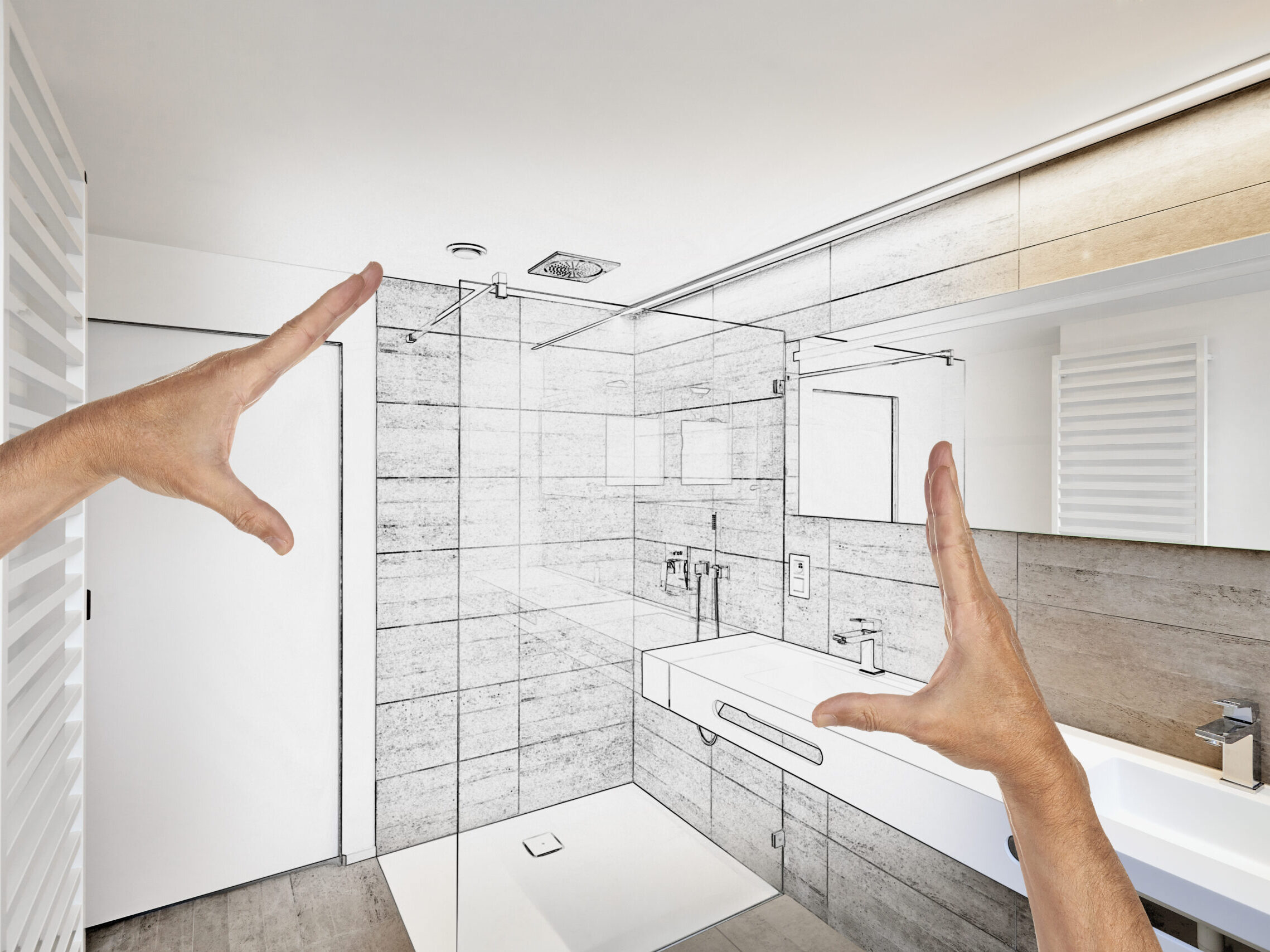 Hands show plans of a renovation for a bathroom to communicate an idea