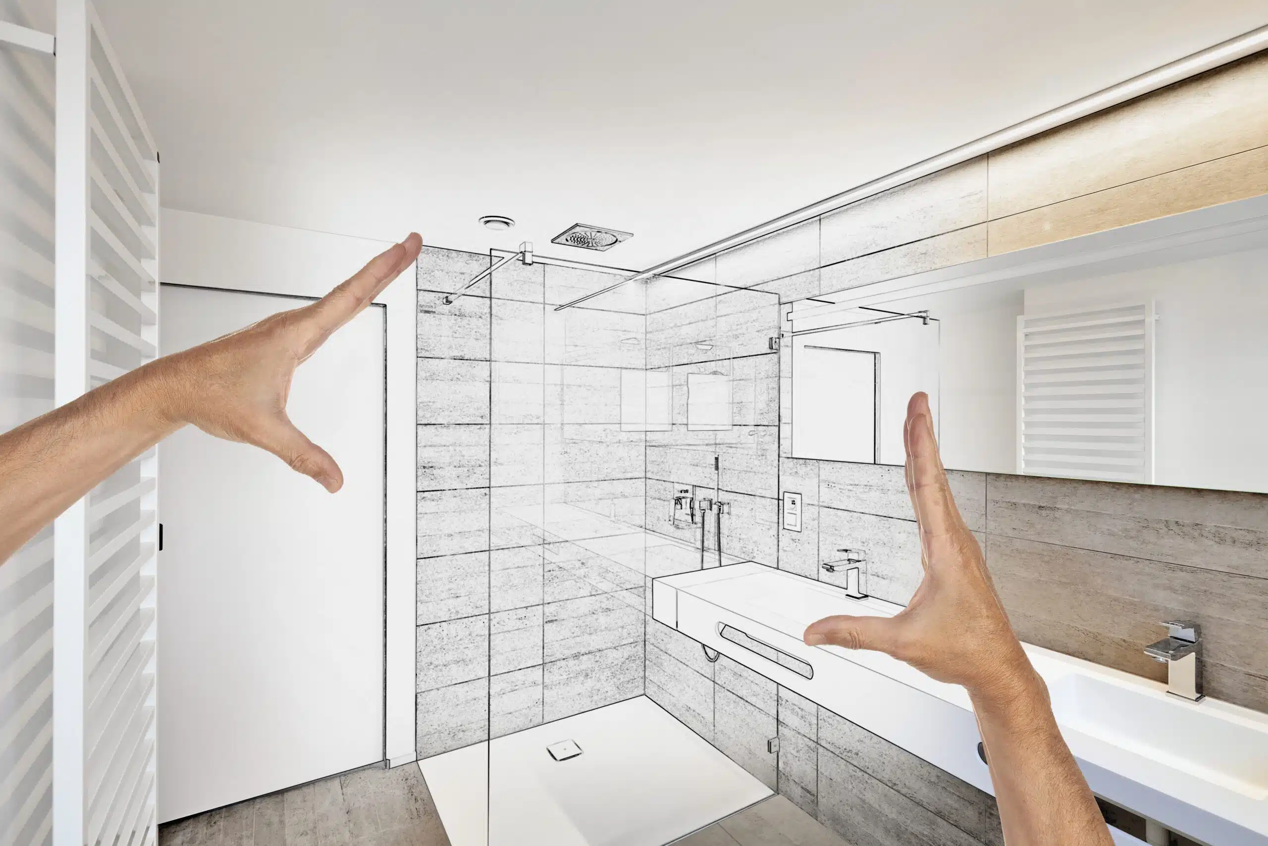 Hands show plans of a renovation for a bathroom to communicate an idea